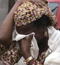 A woman weeps in the aftermath of the bomb blast at the UN Office in Abuja
